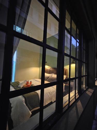 a view of a bed through a window at 85 Boutique Hotel in Ipoh