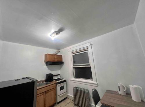 a small kitchen with a stove and a window at Private Room #3 in Philadelphia