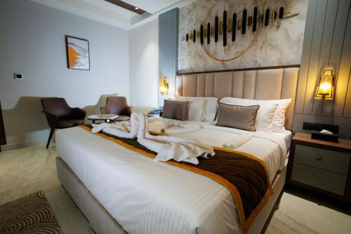 a hotel room with a large bed with towels on it at AJ GRAND ELITE HOTEL in Mangalore