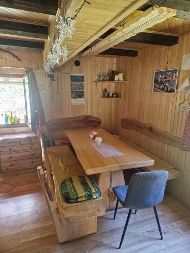 a dining room with a wooden table and chairs at Koča v gozdu in Bled