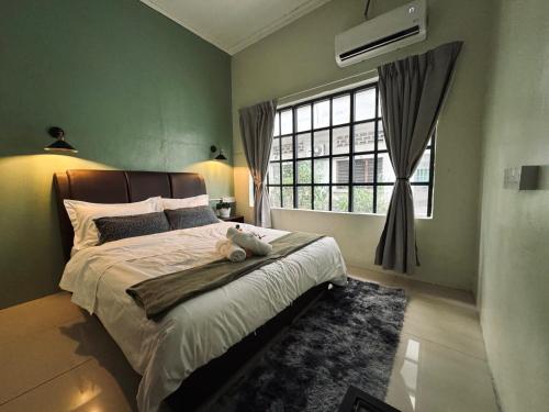 a bedroom with a bed with a teddy bear on it at 85 Boutique Hotel in Ipoh
