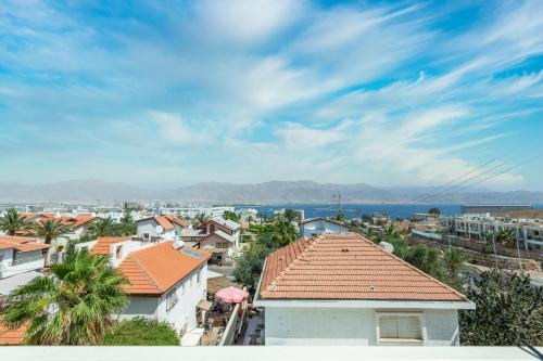 a view of a city with buildings and the ocean at Villa Li Eilat in Eilat