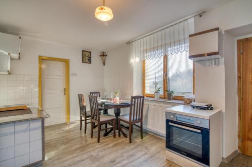 a kitchen and dining room with a table and chairs at Farmhouse Blackberry Pool & Wellness- Happy Rentals in Vransko