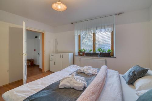 a bedroom with a bed with towels on it at Farmhouse Blackberry Pool & Wellness- Happy Rentals in Vransko