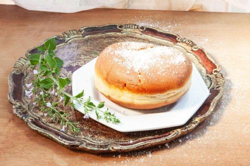 a donut sitting on a plate on a table at Farmhouse Blackberry Pool & Wellness- Happy Rentals in Vransko