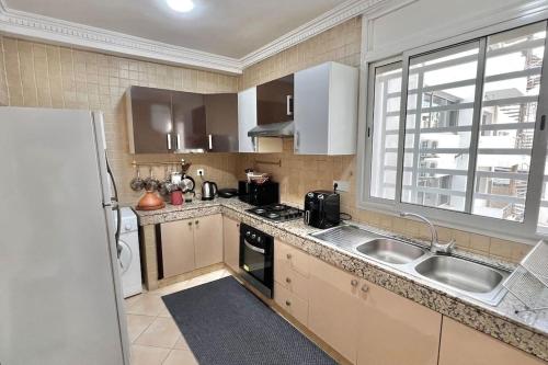 a kitchen with a sink and a counter top at H9 Appartement flambant neuf au centre de Rabat Hassan in Rabat