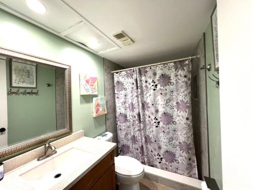 a bathroom with a sink and a shower curtain at Bayshore Yatch Tennis Condo 2br 3 beds, Walking Distance to Beautiful Quite Beach in Clearwater Beach