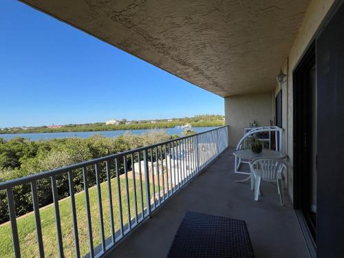 a balcony with a table and a view of the water at Bayshore Yatch Tennis Condo 2br 3 beds, Walking Distance to Beautiful Quite Beach in Clearwater Beach
