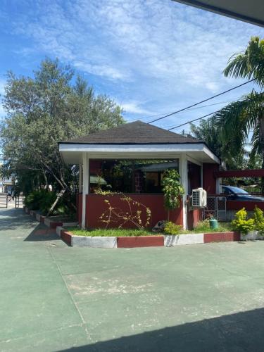 a small red building with a porch at Hotel GIRMA-2 in Pointe-Noire