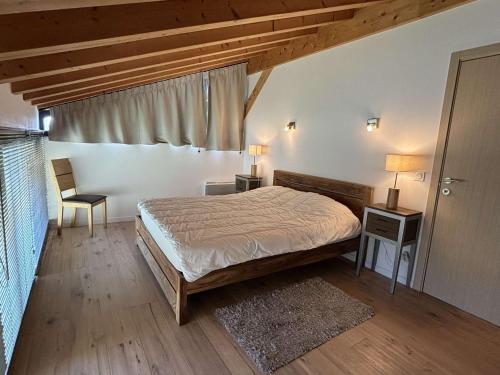 a bedroom with a bed and two tables and a window at Chalet Notre-Dame-de-Bellecombe, 8 pièces, 15 personnes - FR-1-595-1 in Notre-Dame-de-Bellecombe