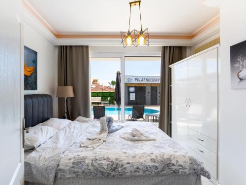 a bedroom with a bed and a pool at alanya polat holiday village in Alanya