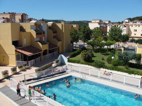 un groupe de personnes debout dans une piscine dans l'établissement Studio cabine avec piscine, 4 couchages, Gruissan - FR-1-229-60, à Gruissan