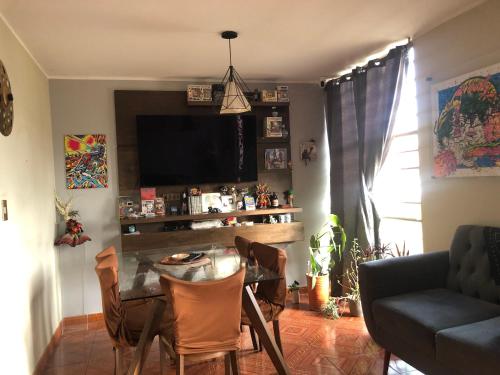 a living room with a table and a tv at condominio la muralla in Lima