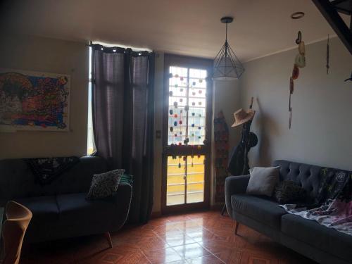 a living room with a couch and a window at condominio la muralla in Lima