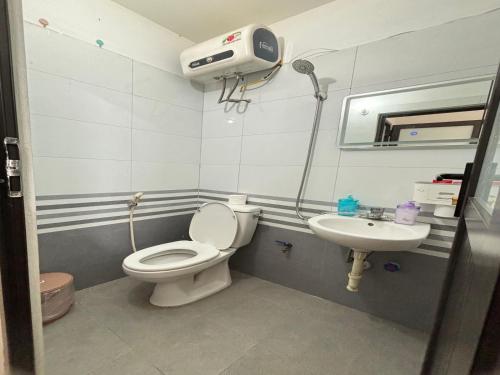 a bathroom with a toilet and a sink at Pan Housing Hostel & Residence in Hanoi