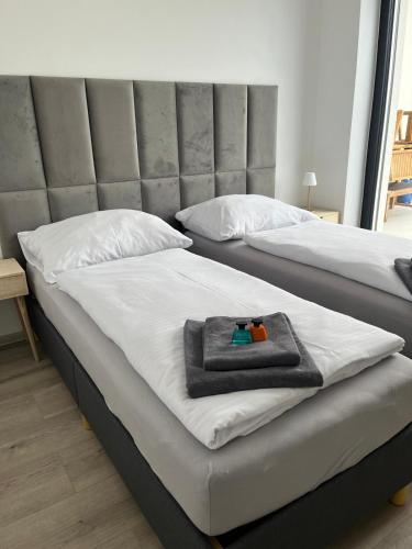 two beds with towels on them in a bedroom at Golf Villa Stella s bazénom in Šajdíkove Humence