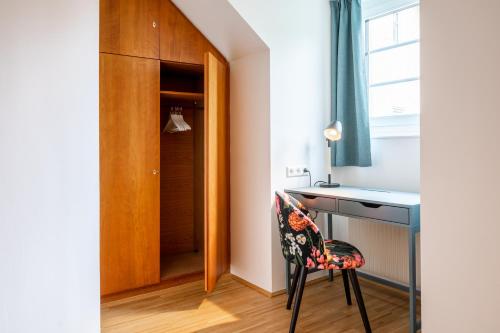 a room with a desk and a chair next to a door at Apartment Sonnleitner in Kötschach
