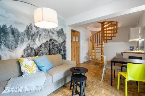 a living room with a couch and a dining room at Apartment Sonnleitner in Kötschach