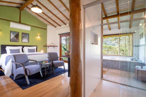 a bedroom with a large bed and a bathroom at Pousada Casa Campestre in Gonçalves