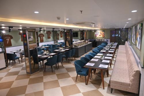a restaurant with tables and chairs in a room at Ra Vista in Kolkata