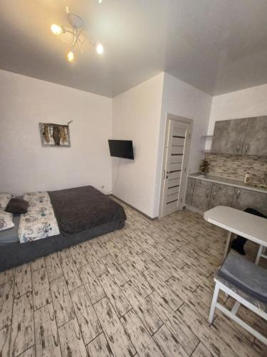 a bedroom with a bed and a desk and a table at Гостьовий будинок Осокорки in Kyiv