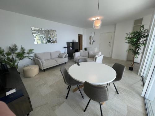 a living room with a white table and chairs at Gli Scogli Luxury Residence Hotel in Chiavari