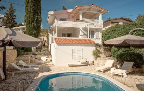 a house with a swimming pool in front of a house at Stunning Home In Vrboska With Kitchen in Vrboska
