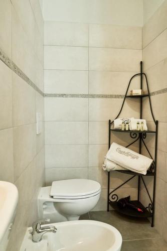 a bathroom with a white toilet and a sink at Castellinuzza in Greve in Chianti