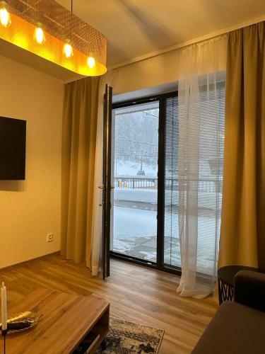 a living room with a large sliding glass door at La Victoria in Janske Lazne