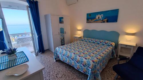 a bedroom with a bed and a view of the ocean at Casa del Mare in Ischia