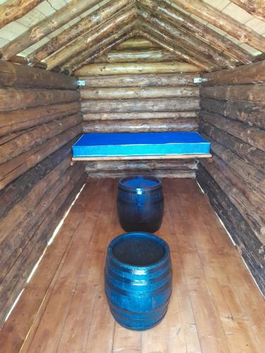 Zimmer mit zwei blauen Fässern und einer Matratze in der Unterkunft Bungalov in Miroč