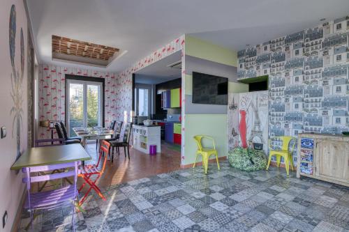 a room with colorful chairs and a dining room at La Lincolnia - with Garden and Seaview - Happy Rentals in Sanremo