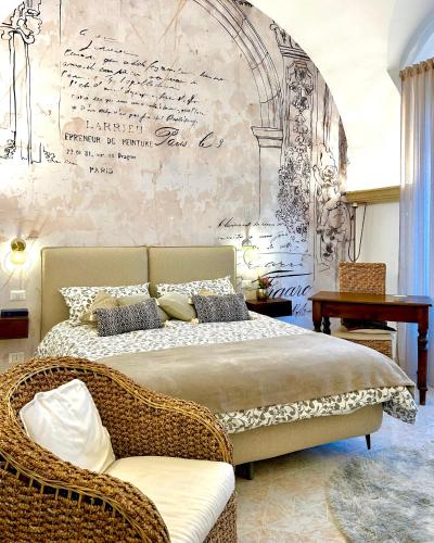 ein Schlafzimmer mit einem Bett und einer Wand mit einem Schreibtisch in der Unterkunft Ex Monastero Pieno Centro storico in Bitetto