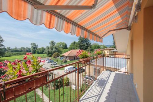 a balcony with a view of a parking lot at Silver Lake Apartment - Happy Rentals in Angera