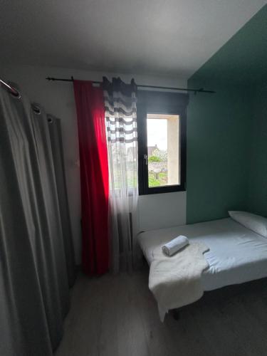 a small room with two beds and a window at Logementprivatif en famille à Disney in Montry