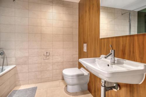 a bathroom with a sink and a toilet and a tub at Large 2 Bed Luxury Soho Apartment in London