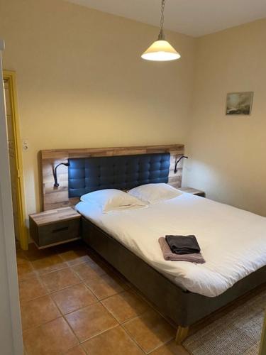 a bedroom with a bed with a hat on it at Château de la Grange Fort in Issoire