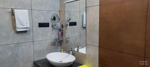 a bathroom with a white toilet and a mirror at Crop and Food Farm Stay in Ferokh