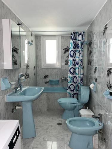 a bathroom with two toilets and a sink and a tub at Aeolian Breeze 2 in Tinos