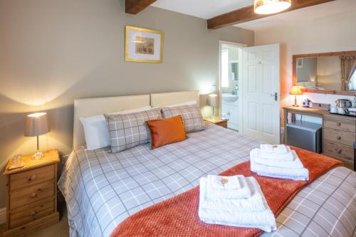 a bedroom with a bed with towels on it at East Hook Farmhouse in Haverfordwest