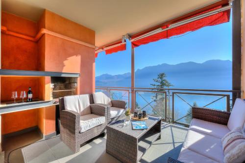 a living room with a balcony with a view at Panorama Fantastico Apt Pool & Beach - Happy Rentals in Ghiffa