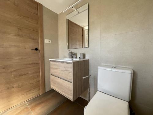 a bathroom with a toilet and a sink and a mirror at YourHouse A Casa Da Corona casa rural in Ourense