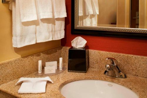 a hotel bathroom with a sink and a mirror at Courtyard Des Moines West/Clive in Clive