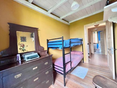 a bedroom with a bunk bed and a dresser at Casa Unica- da Bruno in Colico