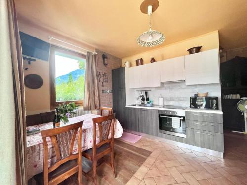 a kitchen with a table and chairs and a window at Casa Unica- da Bruno in Colico