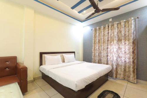 um quarto com uma cama branca e uma janela em SHREE Ram hotel em Gorakhpur