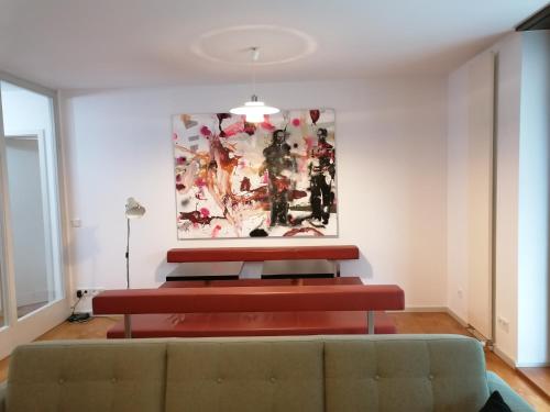 a living room with a couch and a painting on the wall at exklusive FeWo in Architekten-Villa in Meiningen
