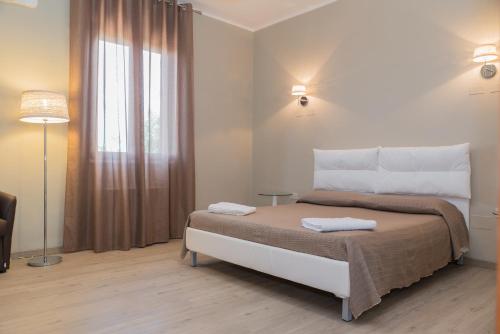 a bedroom with a bed with two towels on it at Hotel Villa Costes in Gallipoli