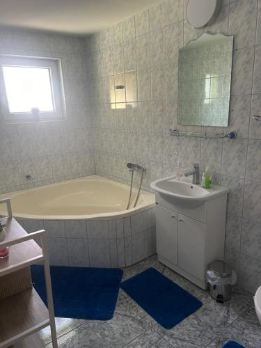 a bathroom with a tub and a sink at Casa Lazar in Săcele