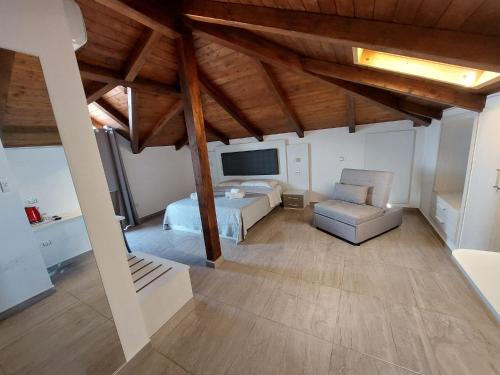 a large bedroom with a bed and a chair at Blue Marine - Free Parking in Tropea